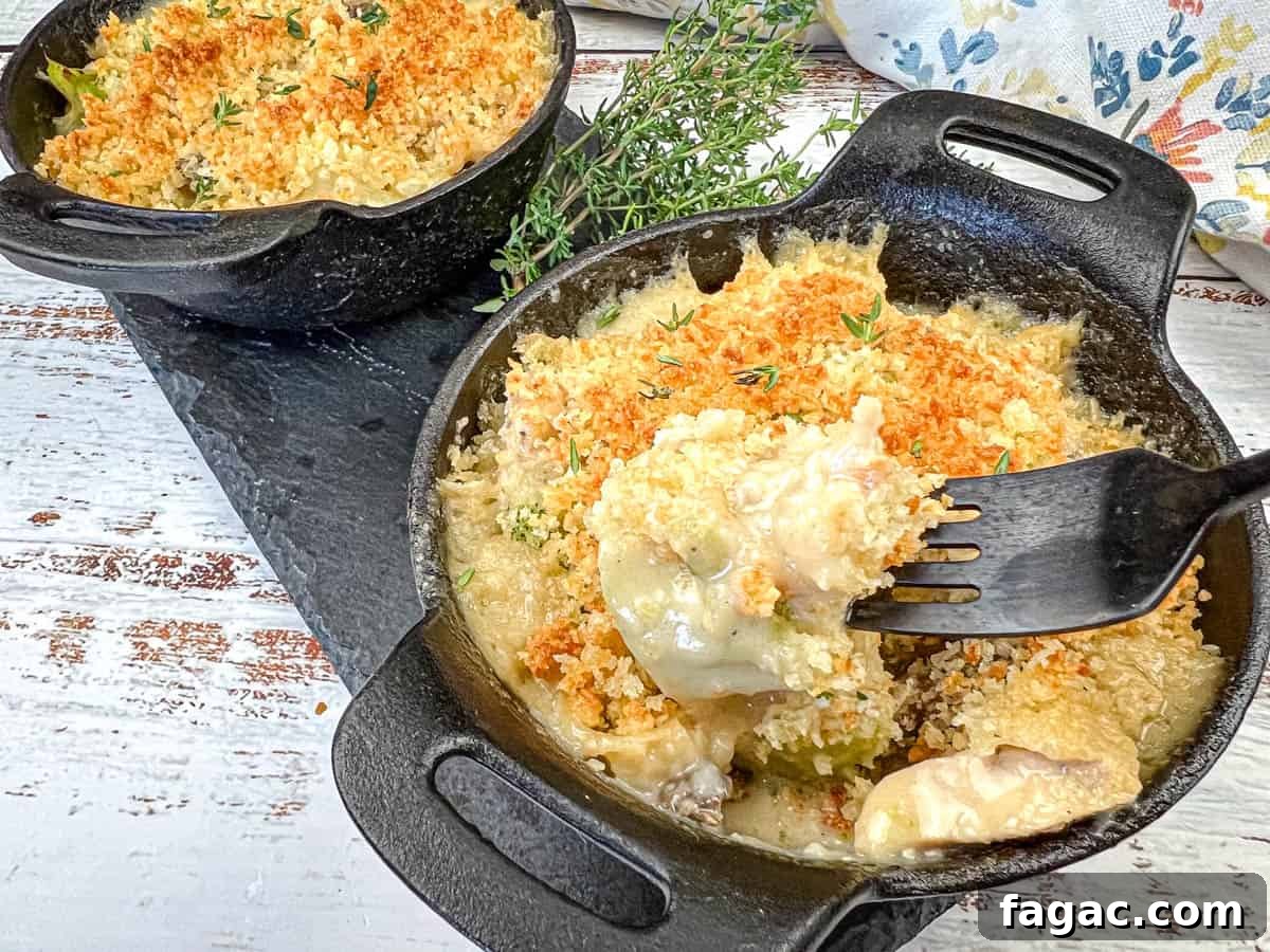 23 Classic Casseroles That Taste Like Grandma’s Comfort Cooking 8 Two cast-iron skillets filled with vintage chicken divan and a fork dishing up one serving.