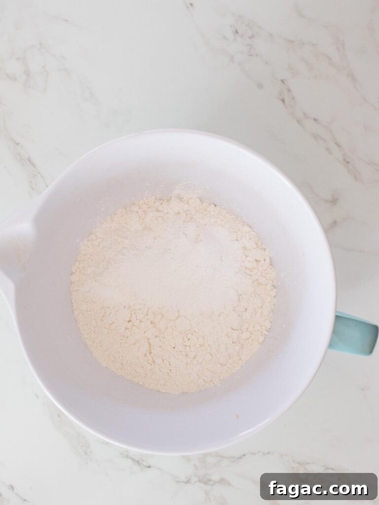 flour with baking powder, baking soda, and salt in a mixing bowl