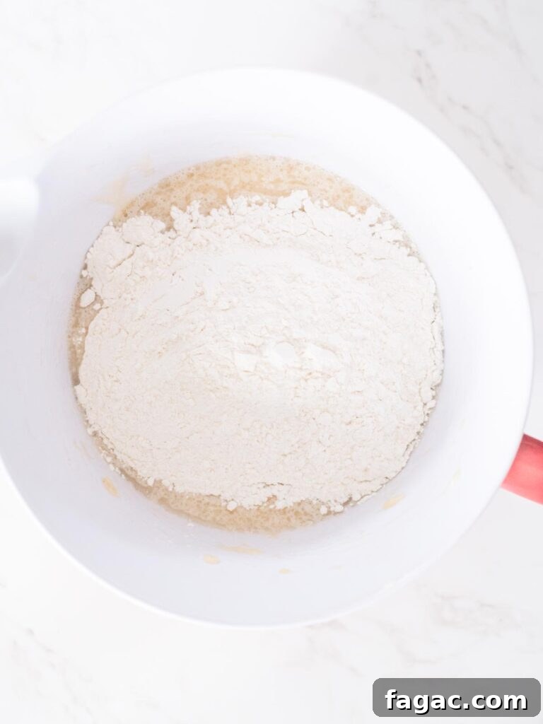 combining the wet and dry ingredients in a mixing bowl for banana muffins