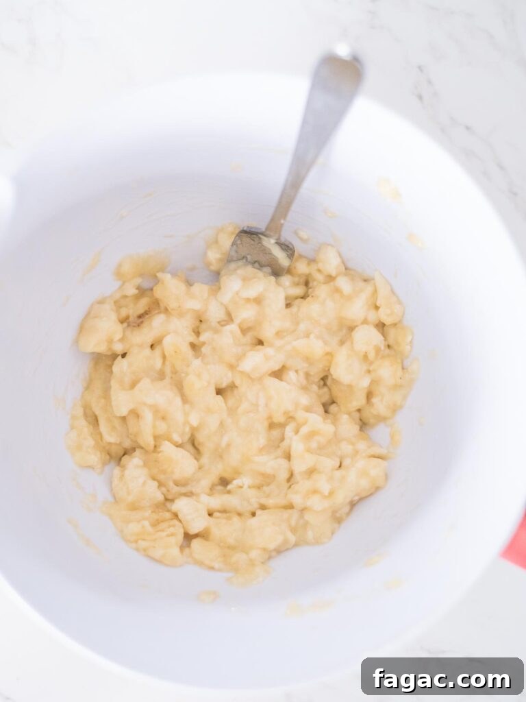 mashed bananas in a mixing bowl