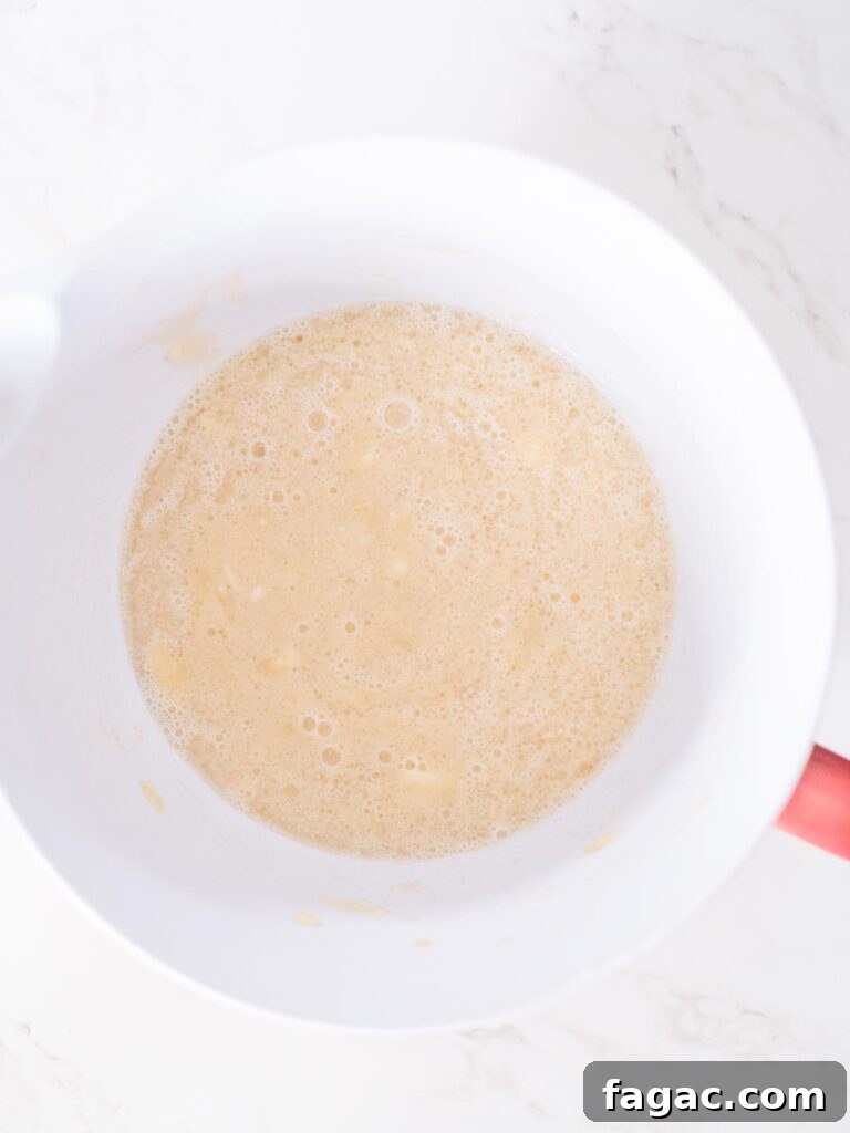 wet ingredients for banana muffins mixed together in a mixing bowl