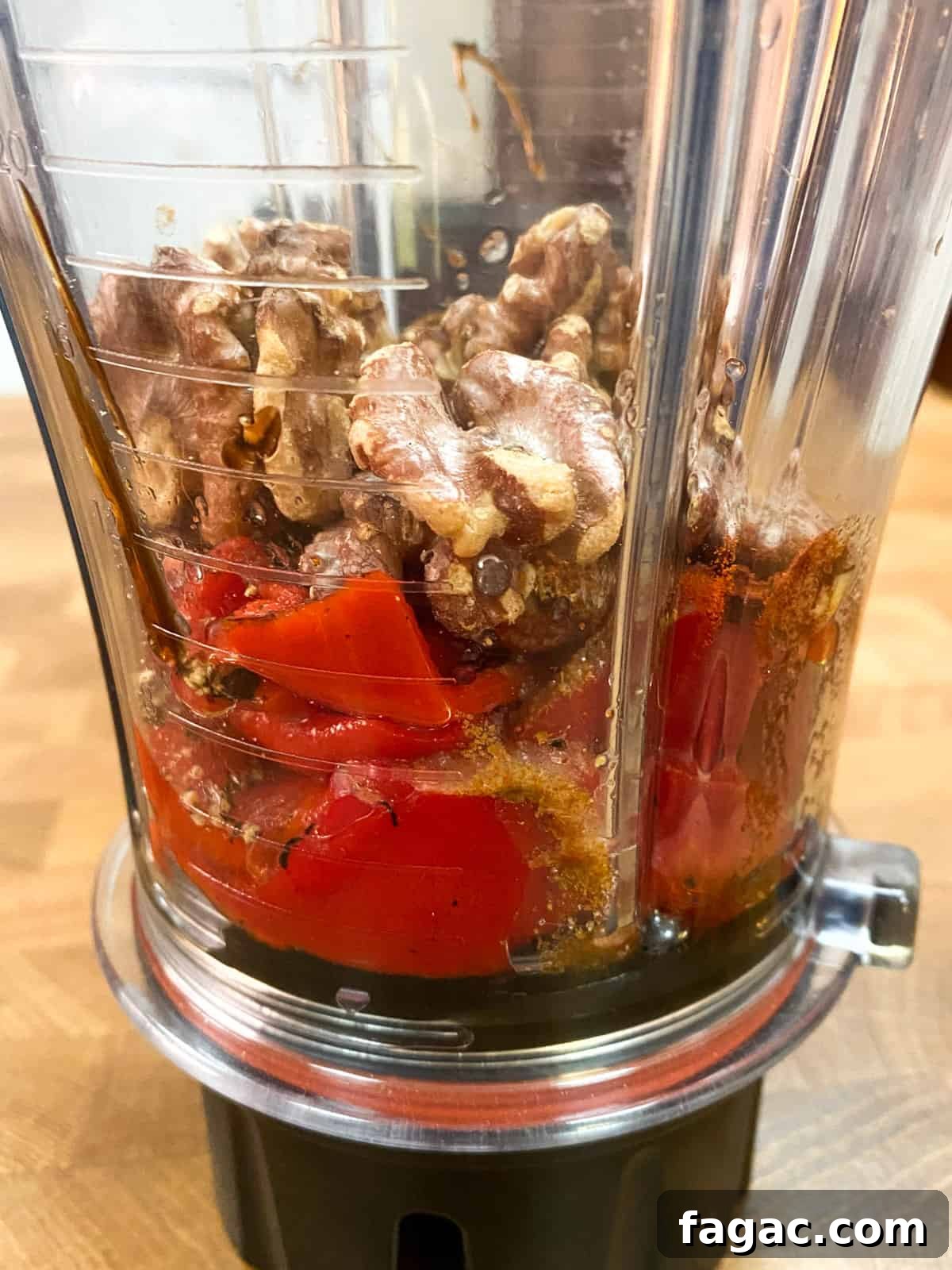 photo of muhummara ingredients in the blender ready to be blended (taken from the side).