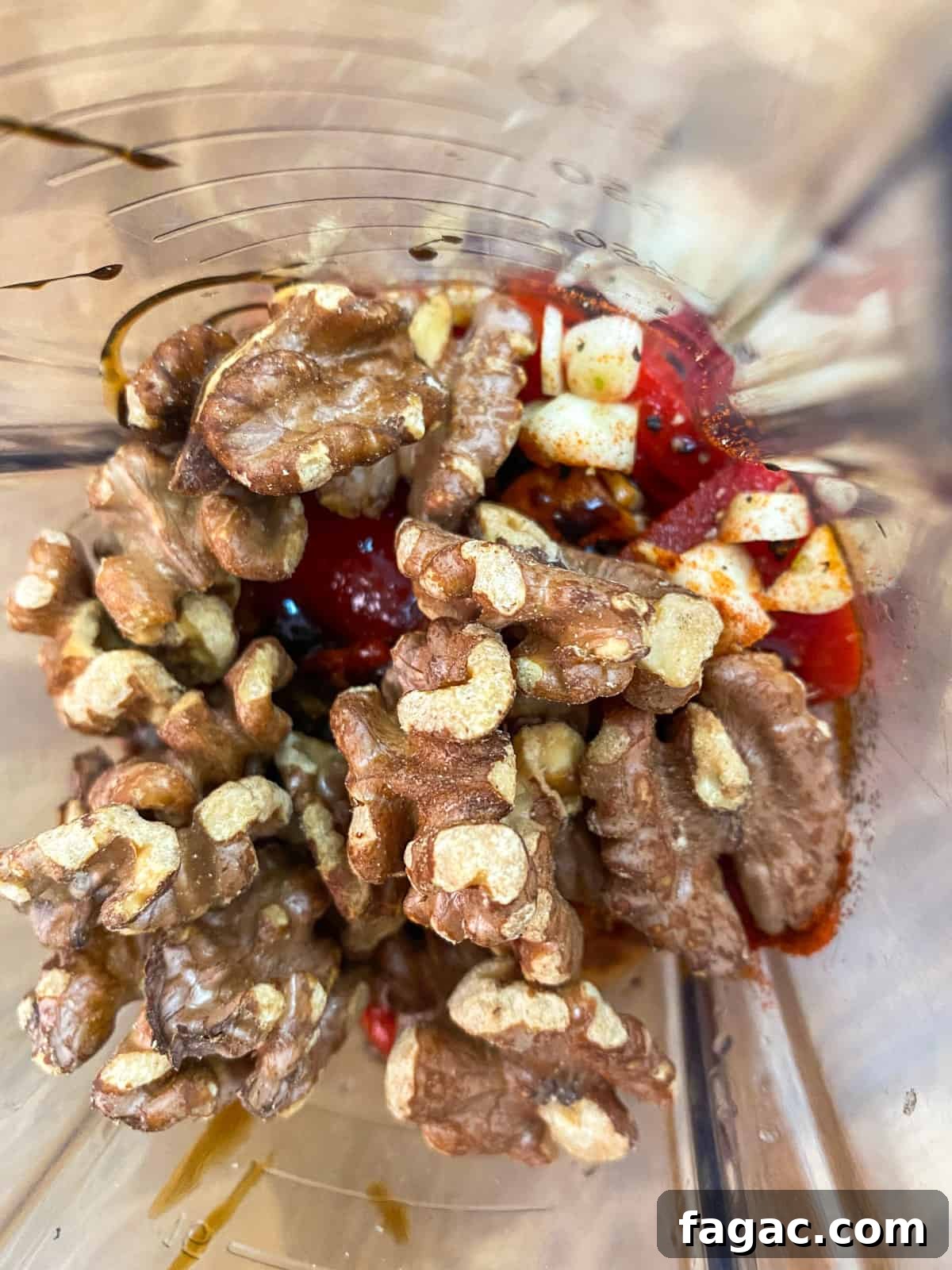 photo of muhummara ingredients in a blender ready to blend (taken from over the top).
