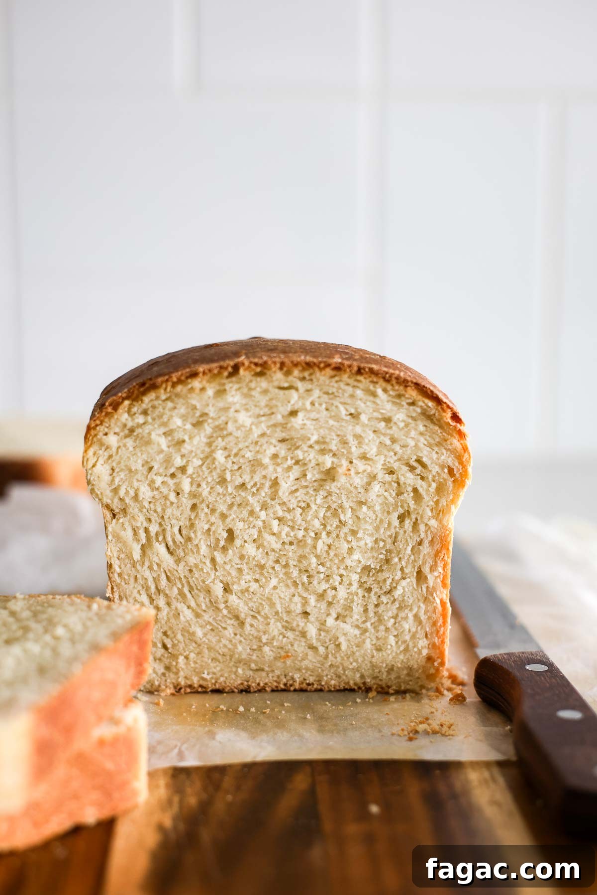 Sourdough Buttermilk Bread Recipe: Tangy Artisan Loaf Guide 2 The crumb of a sourdough buttermilk sandwich bread, slices of bread and a bread knife.