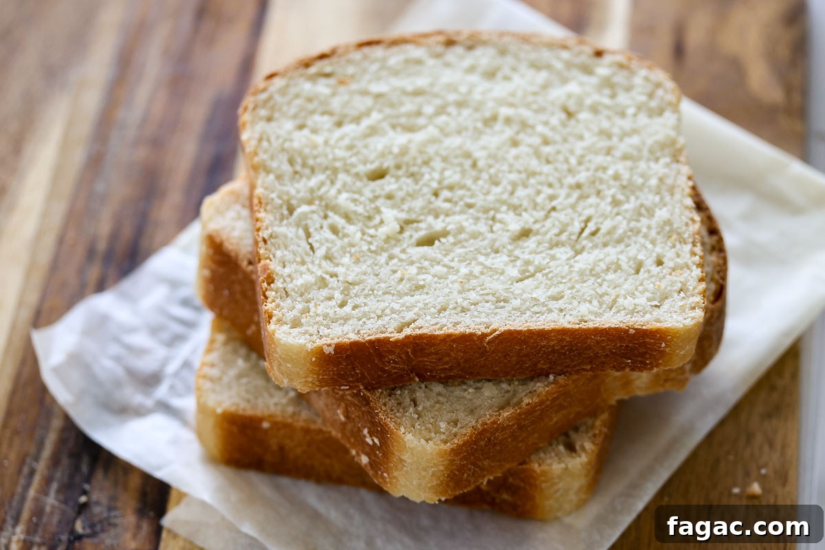 Sourdough Buttermilk Bread Recipe: Tangy Artisan Loaf Guide 12 Three bread slices on top of parchment paper.