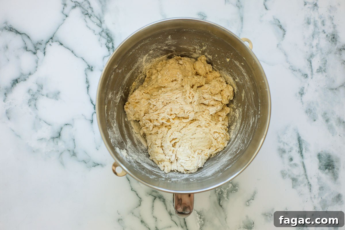 Sourdough Buttermilk Bread Recipe: Tangy Artisan Loaf Guide 5 Shaggy dough in a metal bowl.