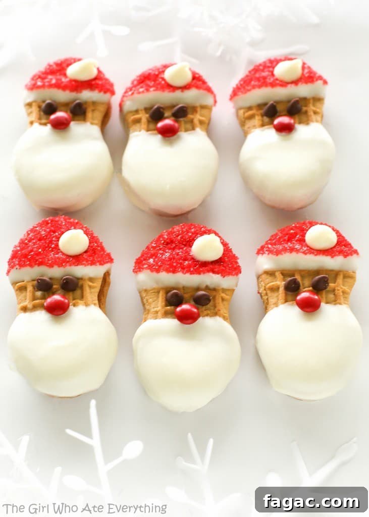 Santa Claus Cookies - easy Nutter Butter based cookies to make with your kids that are fancy enough to give to your friends. the-girl-who-ate-everything.com