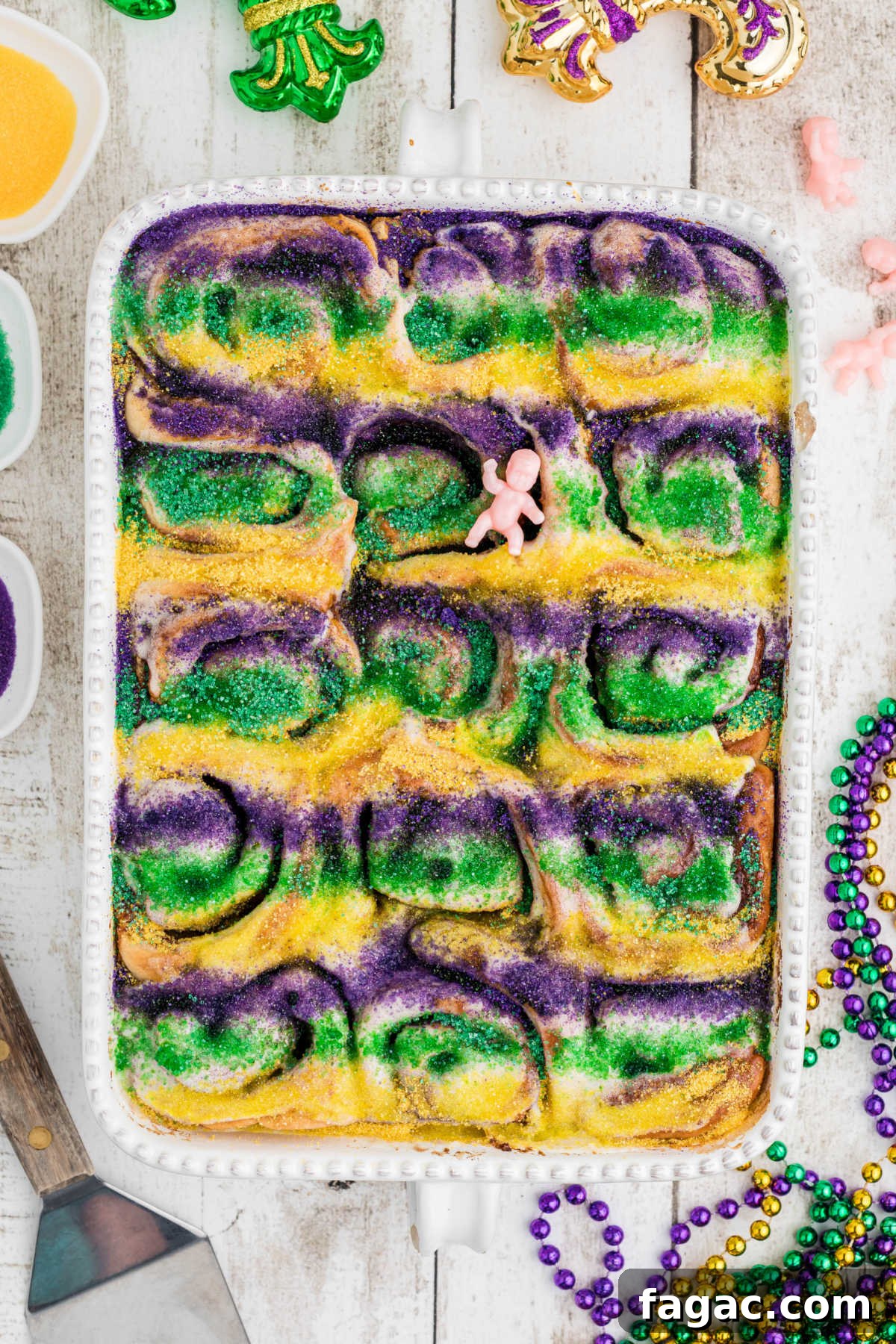 King Cake Cinnamon Roll Recipe: Sweet New Orleans Breakfast 2 Overhead shot of a pan full of king cake cinnamon rolls.