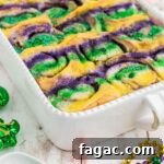 King Cake Cinnamon Roll Recipe: Sweet New Orleans Breakfast 12 A dish full of king cake cinnamon rolls cropped square.