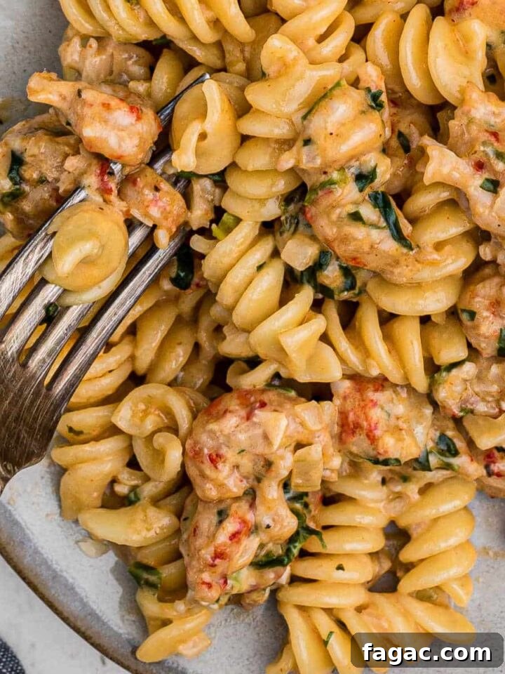 close up of crawfish monica on a plate with a fork digging in