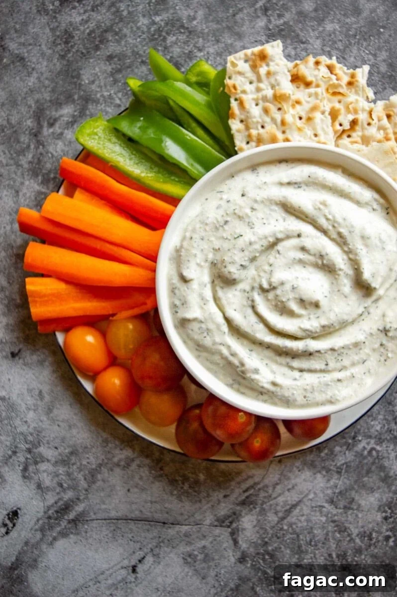 Creamy Herbed Cottage Cheese Dip — Boursin-Style Recipe 4 Top down view of a bowl of whipped cottage cheese dip with vegetable crudites.