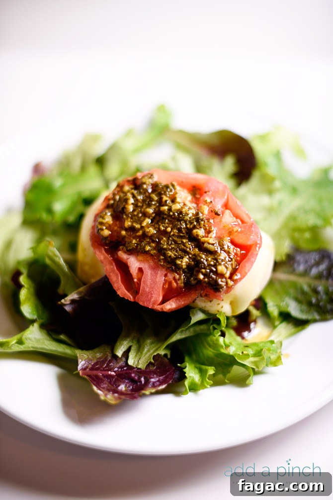 Chicken caprese makes a quick and easy meal that is always a favorite! This baked chicken caprese is made with chicken, mozzarella, tomatoes and pesto! // addapinch.com
