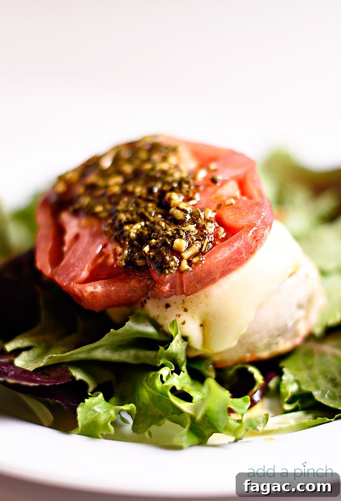 Chicken caprese makes a quick and easy meal that is always a favorite! This baked chicken caprese is made with chicken, mozzarella, tomatoes and pesto! // addapinch.com