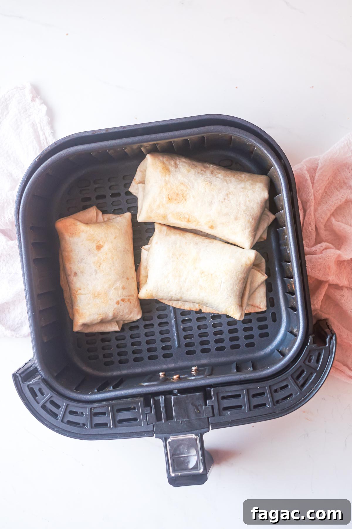 Crispy Air Fryer Breakfast Burrito Recipe 4 top down view of burrito in air fryer basket