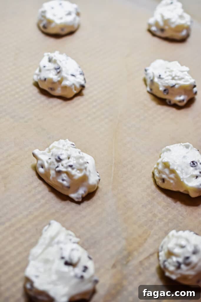 Fluffy Chocolate Chip Cookies Made with Angel Food Cake Mix 7 The cake batter is scooped onto a parchment lined baking sheet.