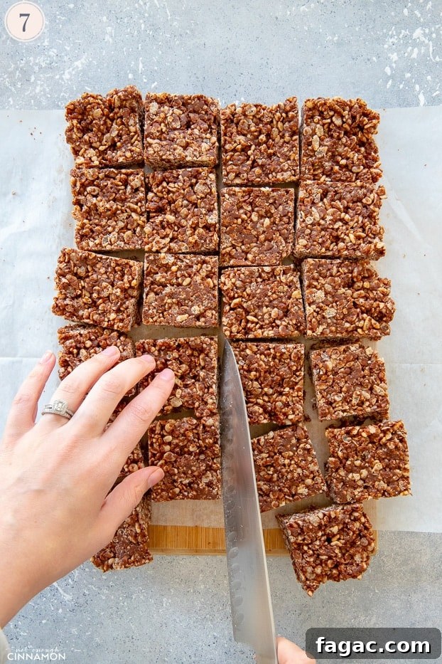 Fudgy Chocolate Rice Krispies Treats 7 Chocolate rice krispies treats cut in squares with a large knife