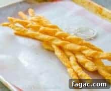 Cheddar Puff Cheese Twists: Crispy Savory Snack Recipe 2 Cheese Twists - On Parchment Paper with Twine