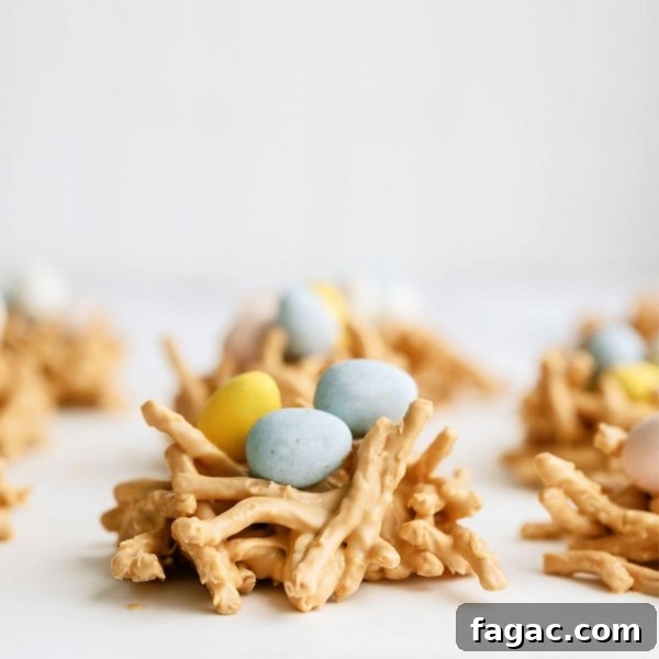 A close up of a Chow Mein Butterscotch Birds Nest Treat topped with chocolate mini eggs, with other nests in the background.