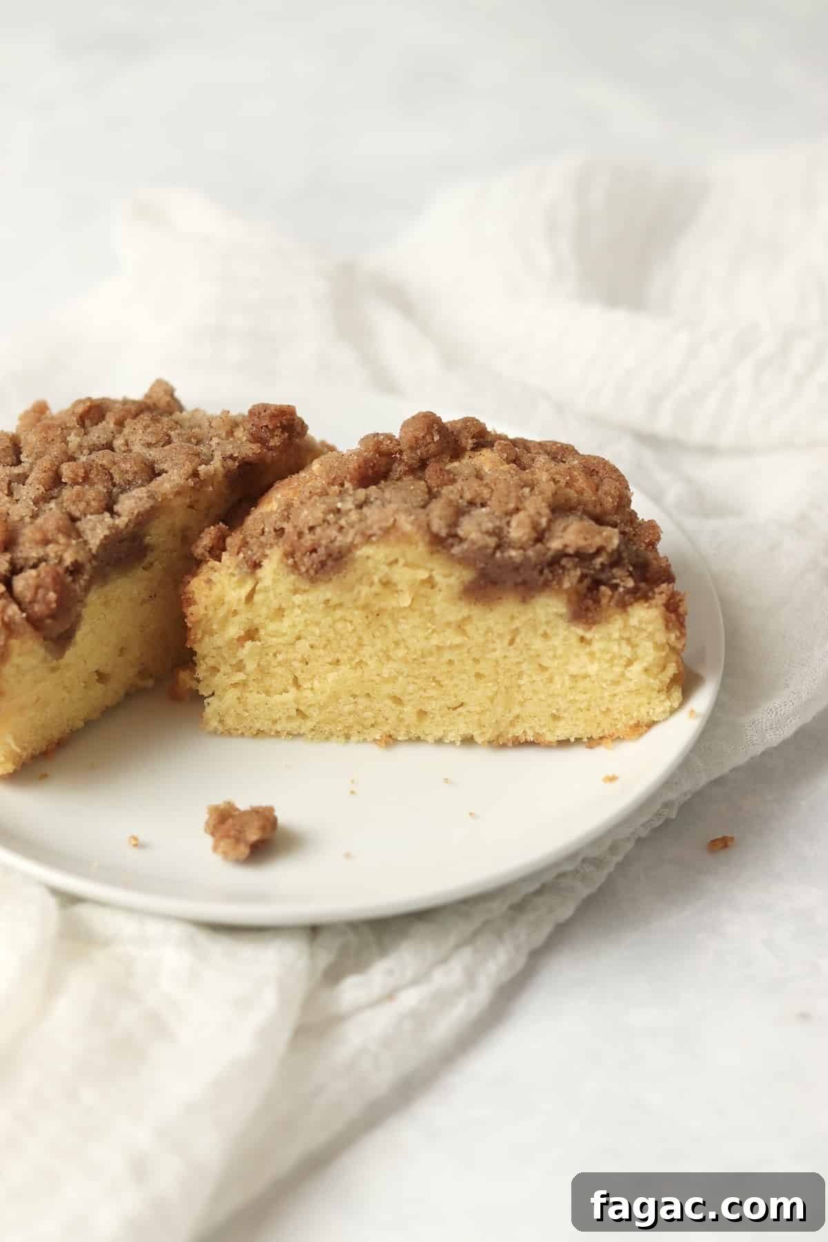 Single serve coffee cake with streusel topping on a small plate.