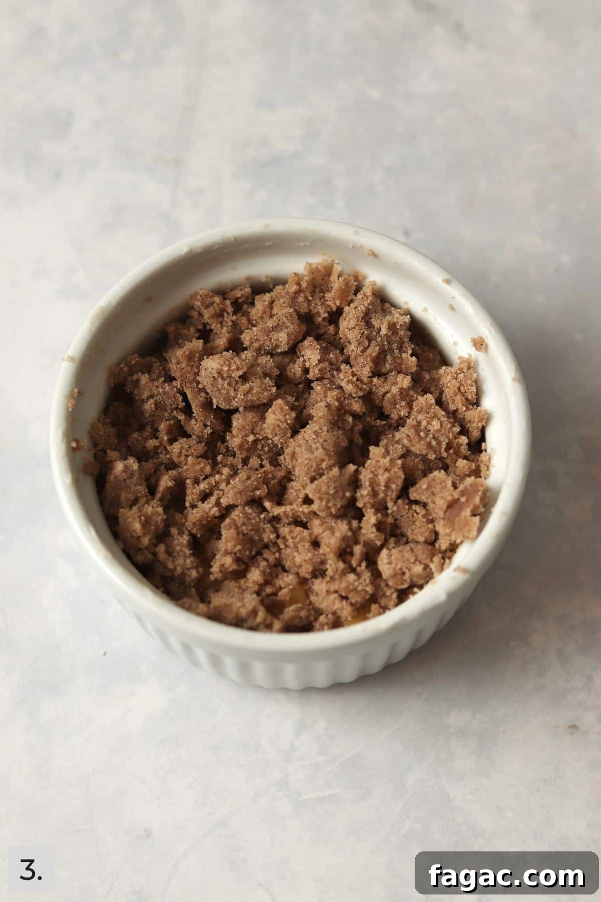 Unbaked coffee cake with streusel topping in a large ramekin.