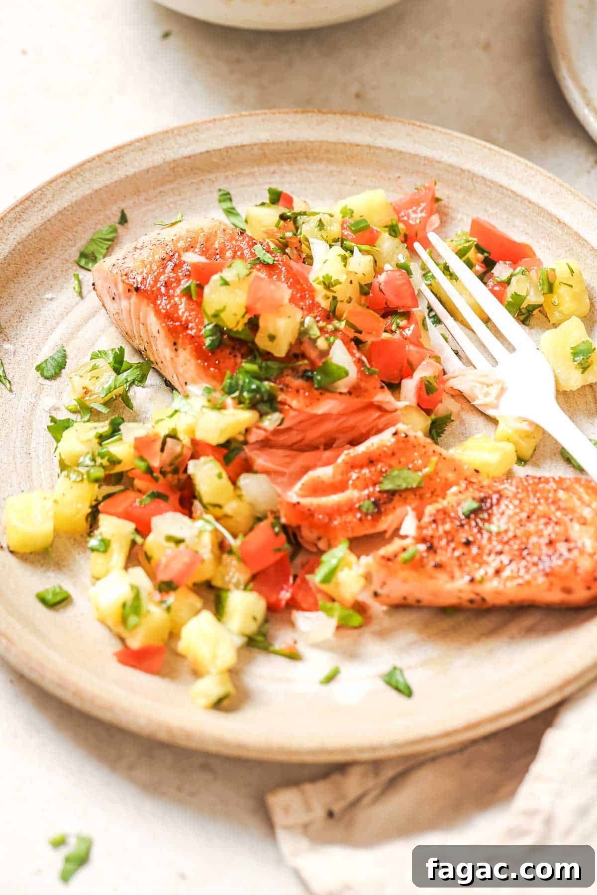 Crispy Pan-Seared Salmon with Fresh Pineapple Salsa 12 Salmon with pineapple salsa on a plate.