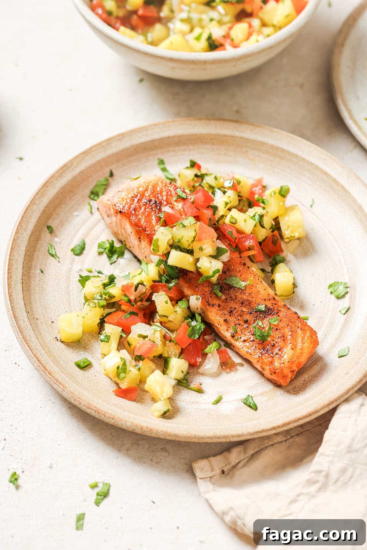 Crispy Pan-Seared Salmon with Fresh Pineapple Salsa 13 A plate with salmon and pineapple salsa.