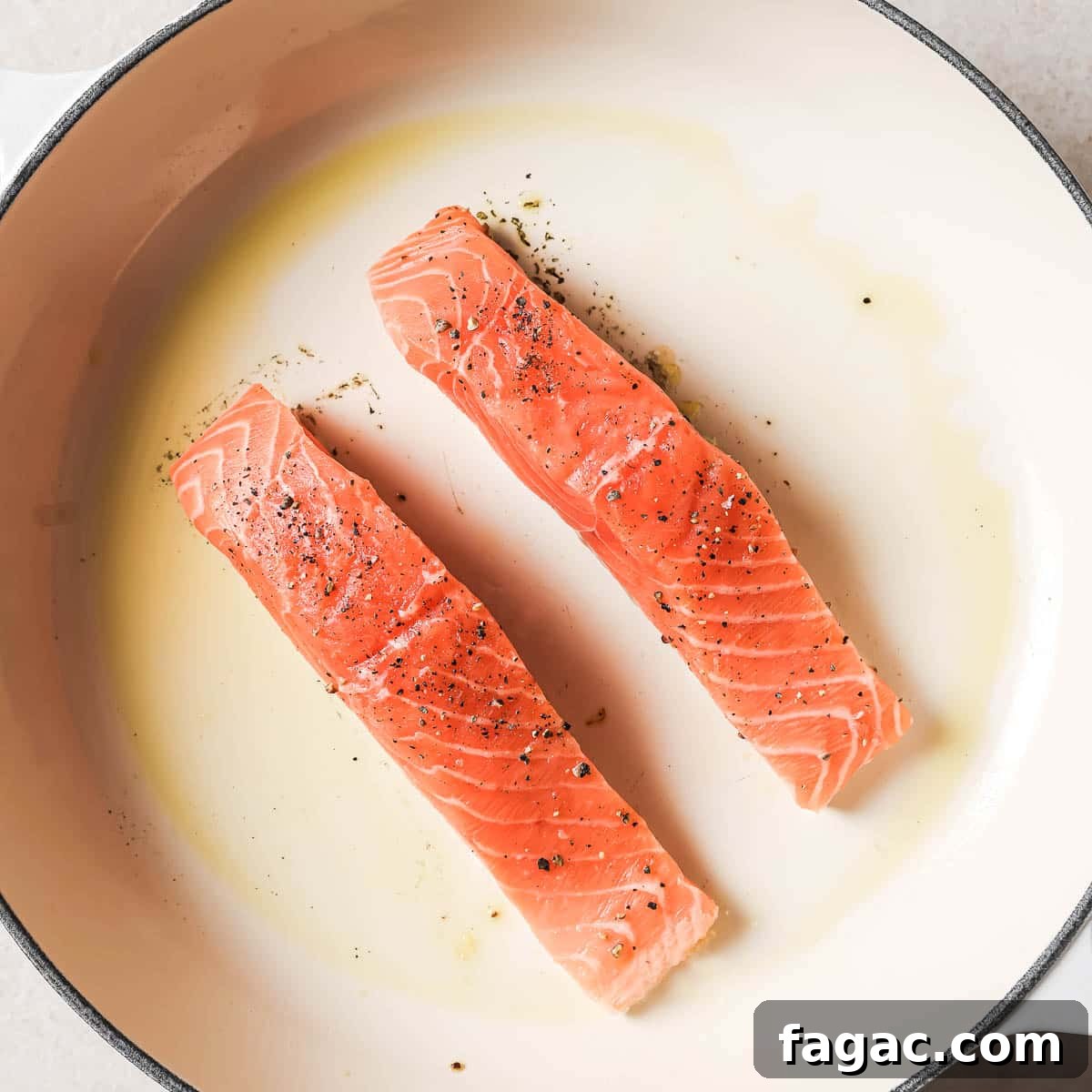 Crispy Pan-Seared Salmon with Fresh Pineapple Salsa 8 Two salmon fillets in a frying pan.