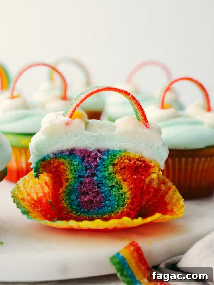 A rainbow cupcake cut in half.