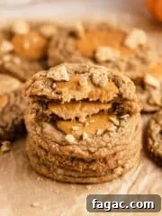 stack of pumpkin cheesecake cookies on parchment paper