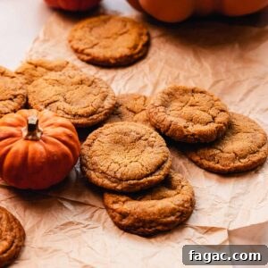 pumpkin spice snickerdoodle cookies on parchment paper