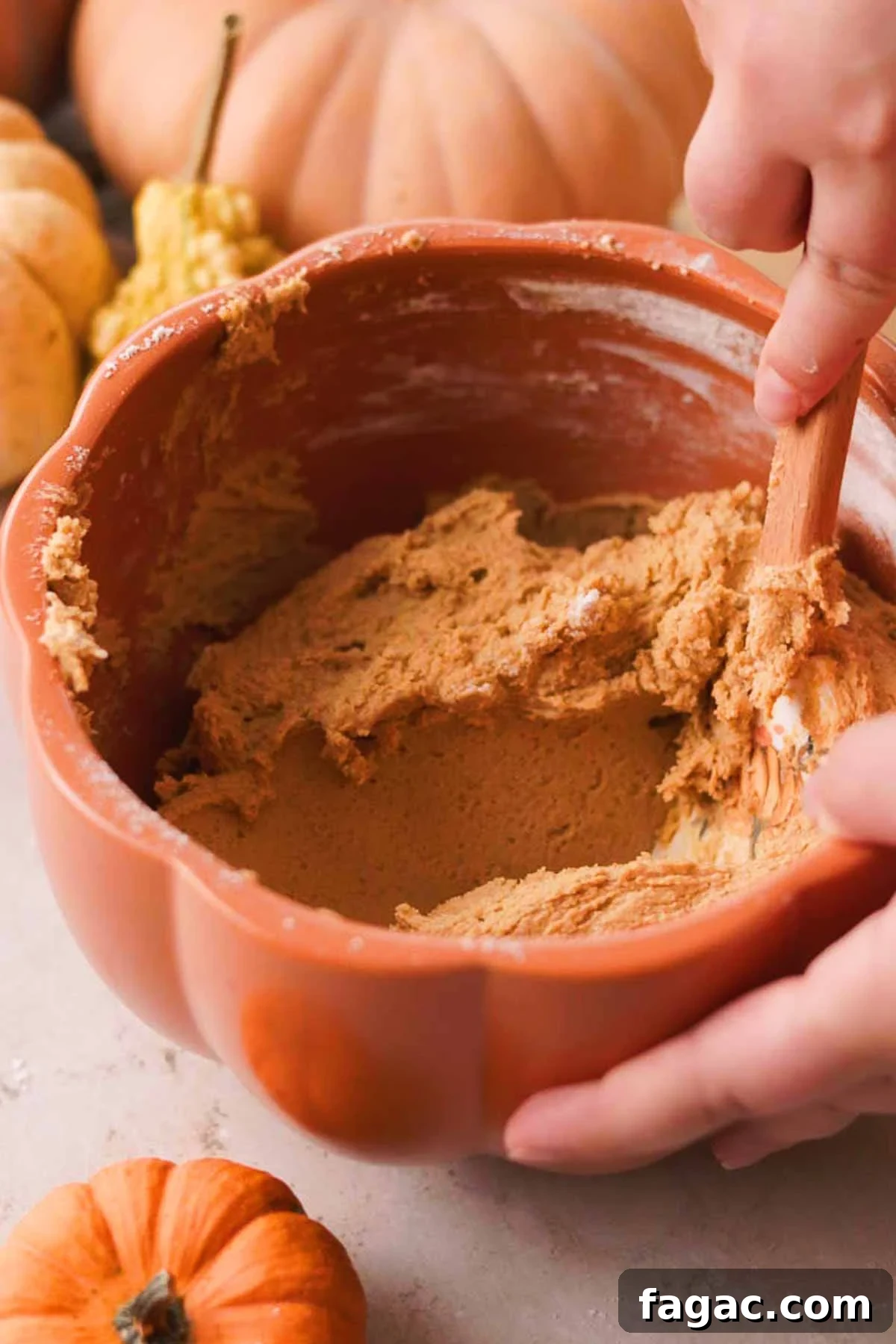 folding flour into the pumpkin spice snickerdoodle cookie dough