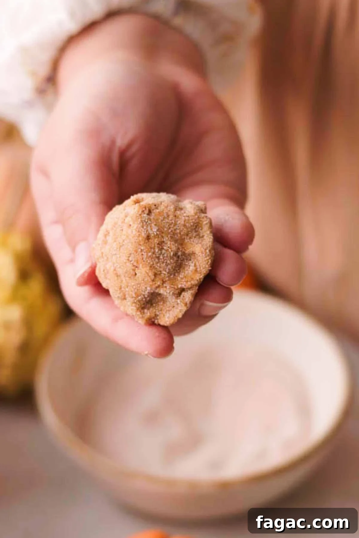coating cookie dough ball in pumpkin spice sugar