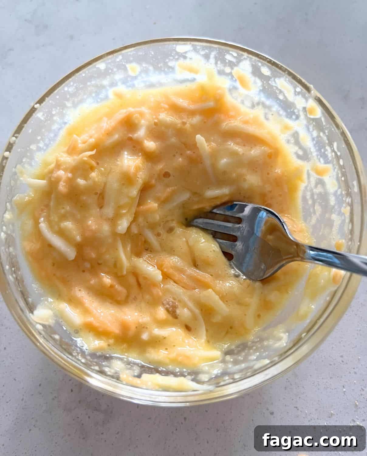 Keto Chaffle Recipes: 3 Delicious Ways to Make Them 4 Egg, flour, and cheese mixed into a bowl.