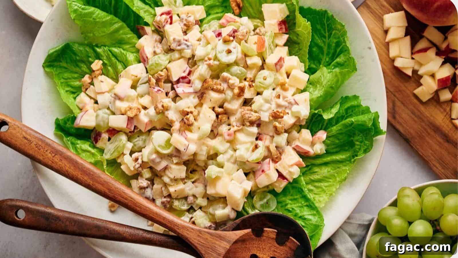 21 Easter Salad Ideas to Refresh Your Holiday Table 14 Waldorf salad on a bed of lettuce, with salad servers resting on top.