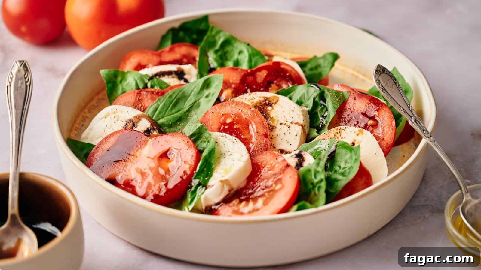 21 Easter Salad Ideas to Refresh Your Holiday Table 19 Caprese salad in a serving bowl, with tomatoes, oil and balsamic glaze nearby.