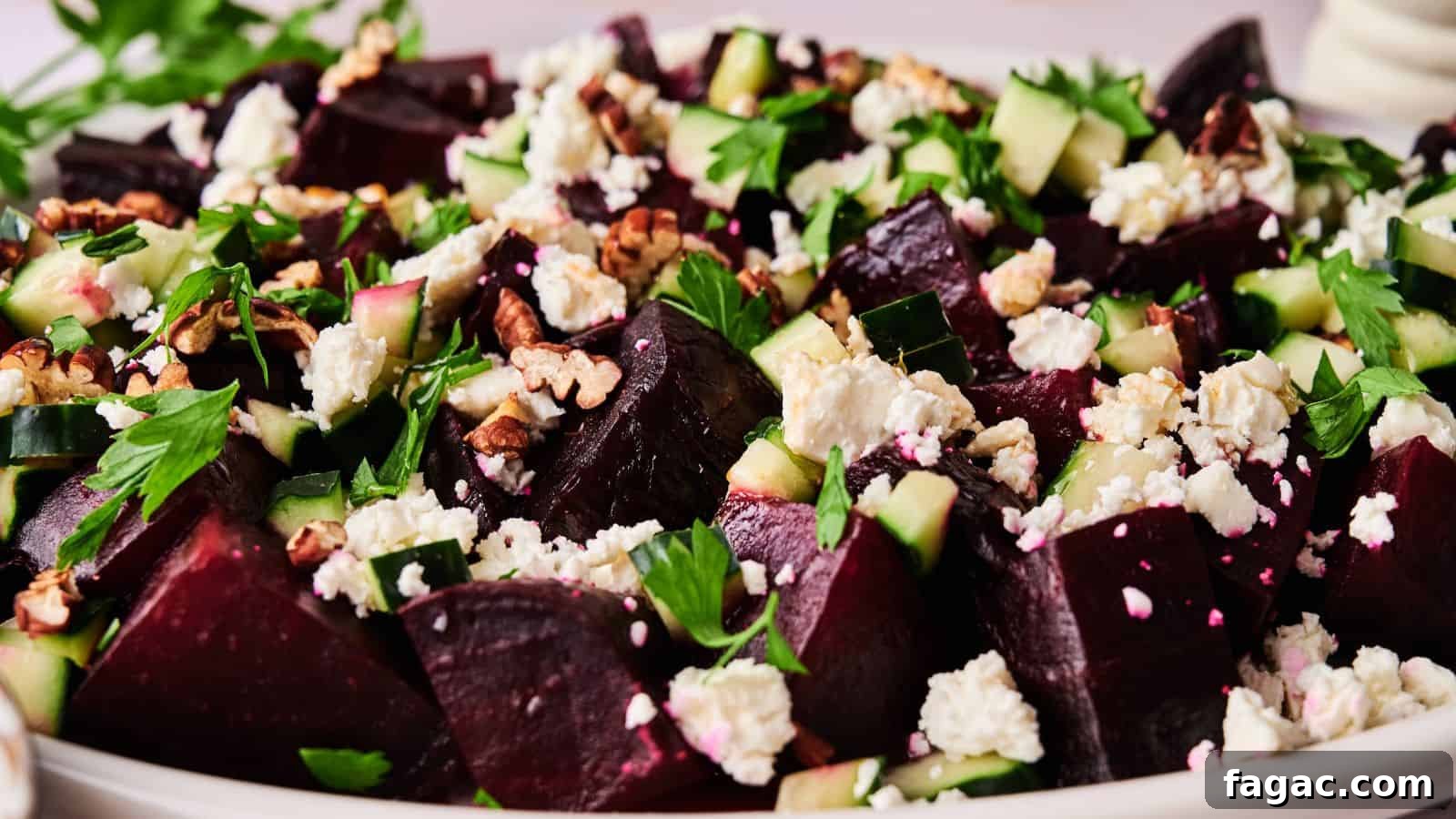 21 Easter Salad Ideas to Refresh Your Holiday Table 21 A close-up of a salad featuring chopped beets, cucumber, feta cheese, walnuts, and fresh herbs on a white plate.