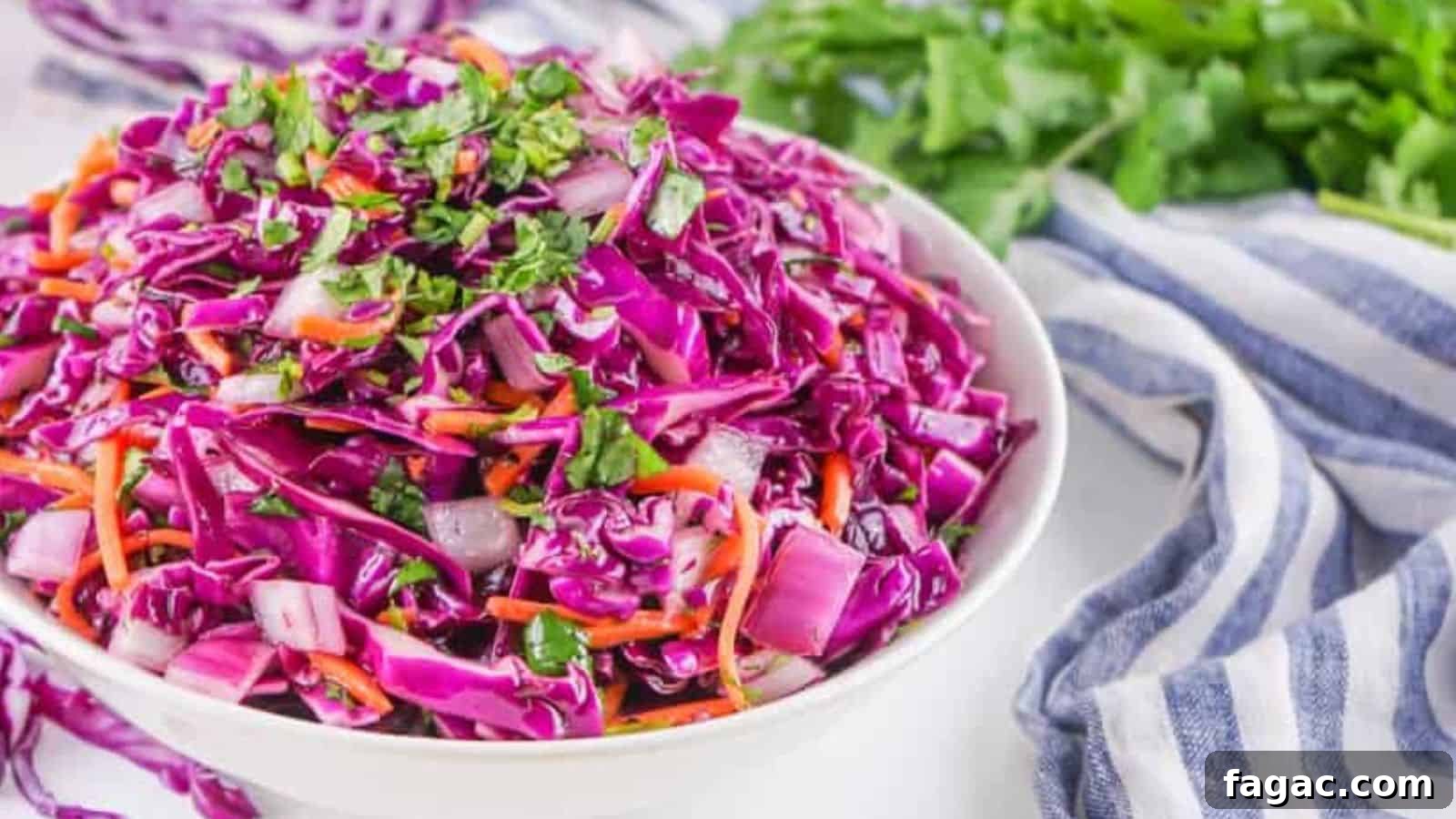 21 Easter Salad Ideas to Refresh Your Holiday Table 9 A bowl of fresh red cabbage coleslaw garnished with herbs.
