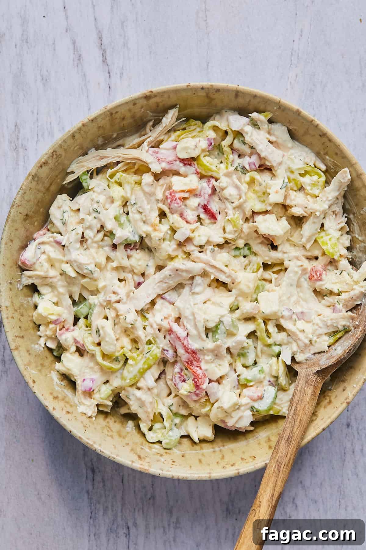 chicken salad ingredients mixed in a bowl