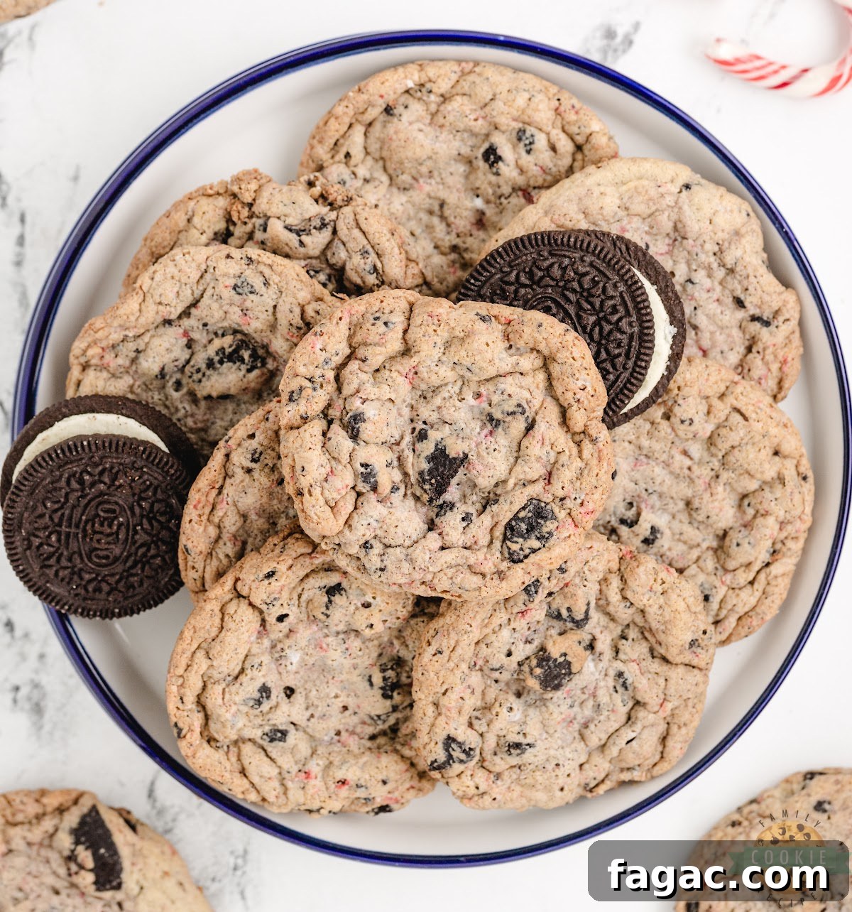 Soft peppermint Oreo cookies on a holiday plate with crushed candy canes scattered around.