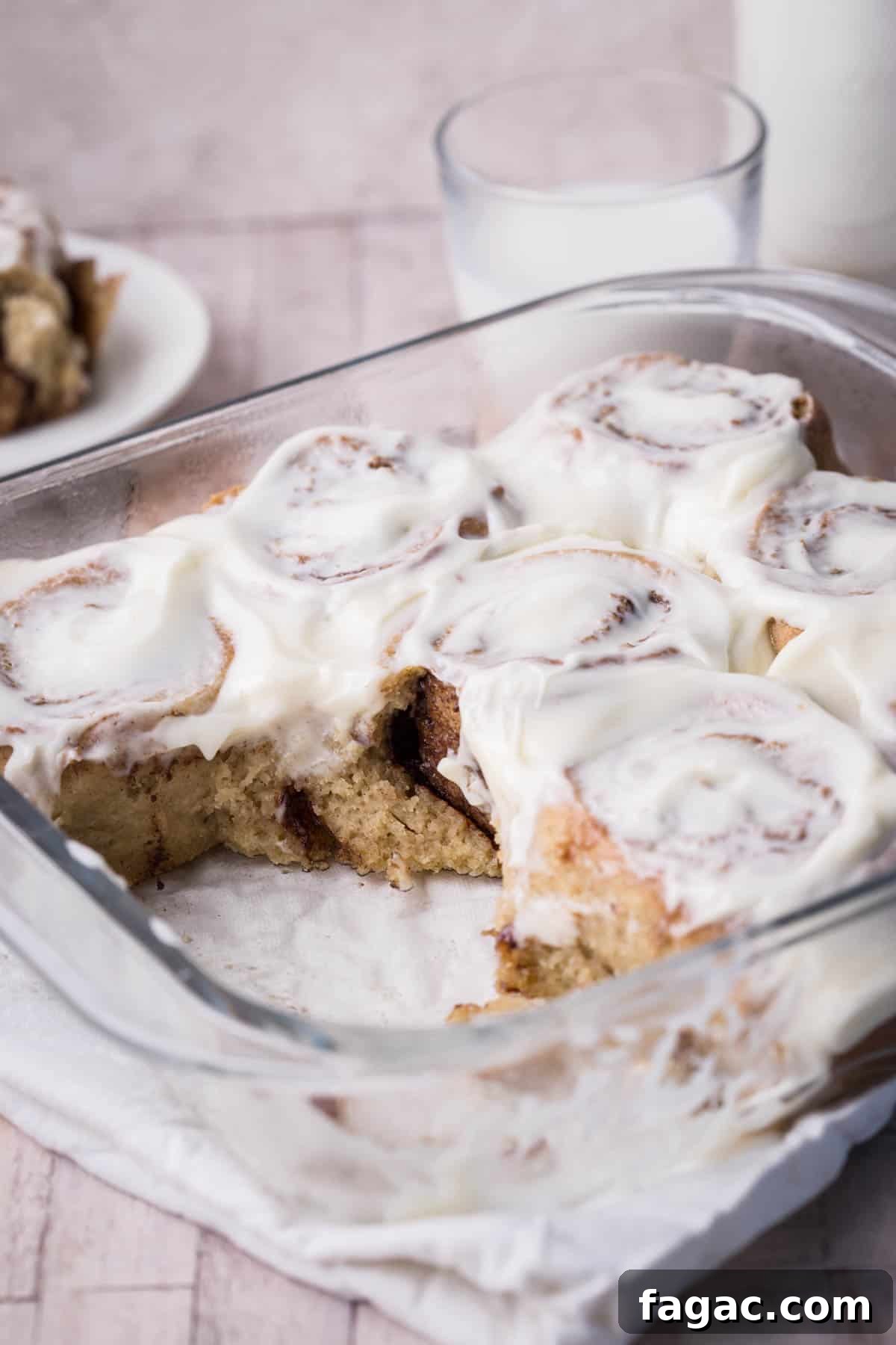 Soft and Fluffy Gluten-Free Cinnamon Rolls Without Xanthan Gum 6 Pan of gluten-free cinnamon rolls with 2 rolls removed showing soft and fluffy inside.