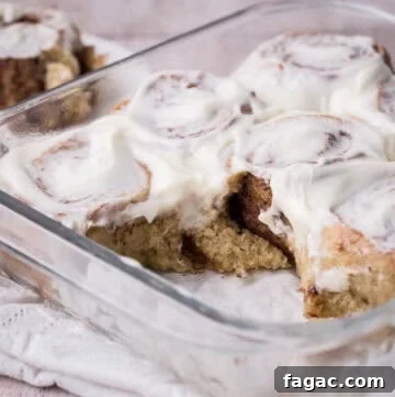 Soft and Fluffy Gluten-Free Cinnamon Rolls Without Xanthan Gum 9 Pan of gluten-free cinnamon rolls with 2 rolls removed showing soft and fluffy inside.