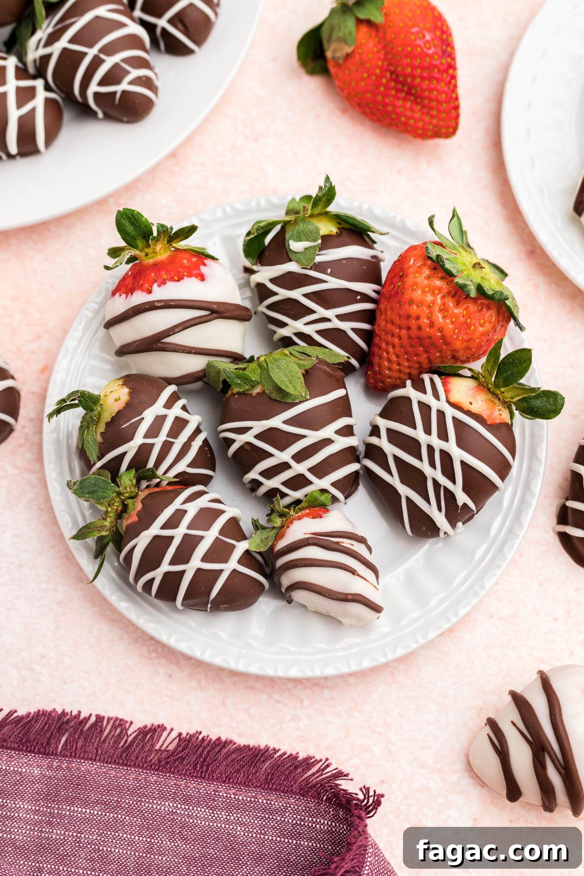 How to Make Chocolate-Covered Strawberries 6 Small white appetizer plate with strawberries added to plate.