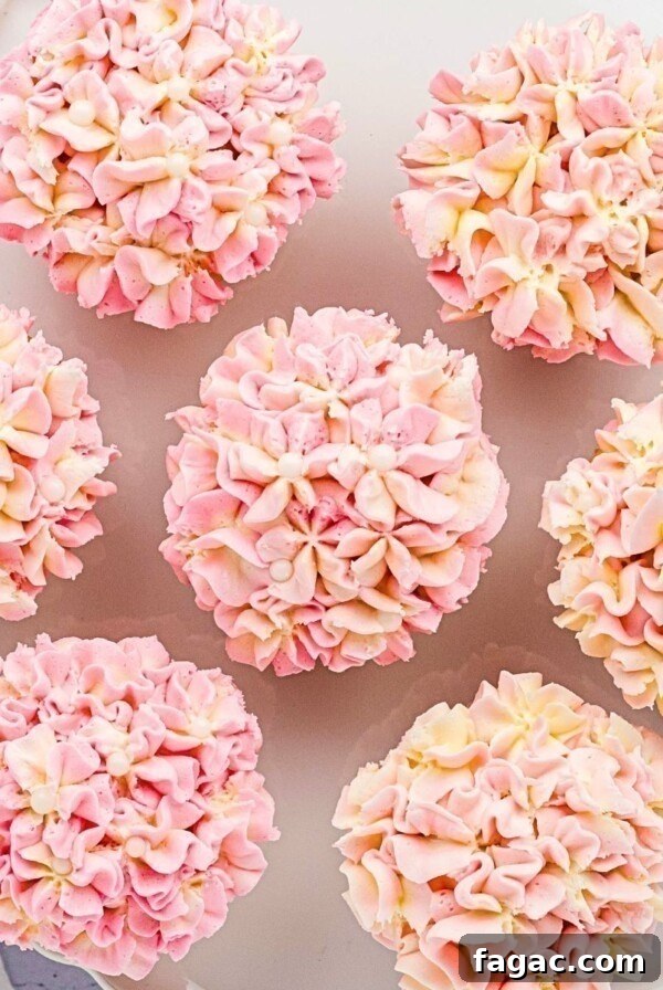 Pink and white pretty hydrangea cupcakes on a white baking dish.