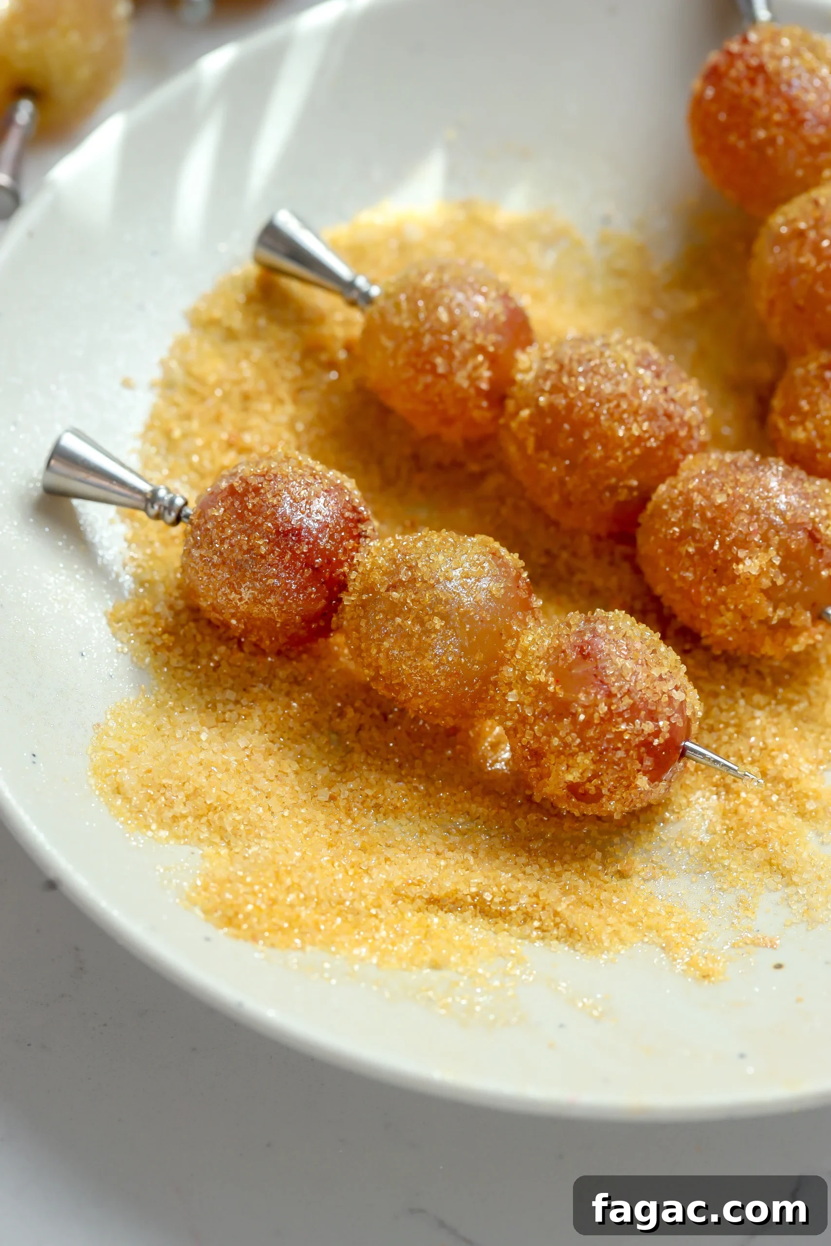 French 75 Grapes: Growing Guide and Wine Uses 2 Lemon sugar coated boozy grapes skewered on cocktail picks with a sparkling finish.