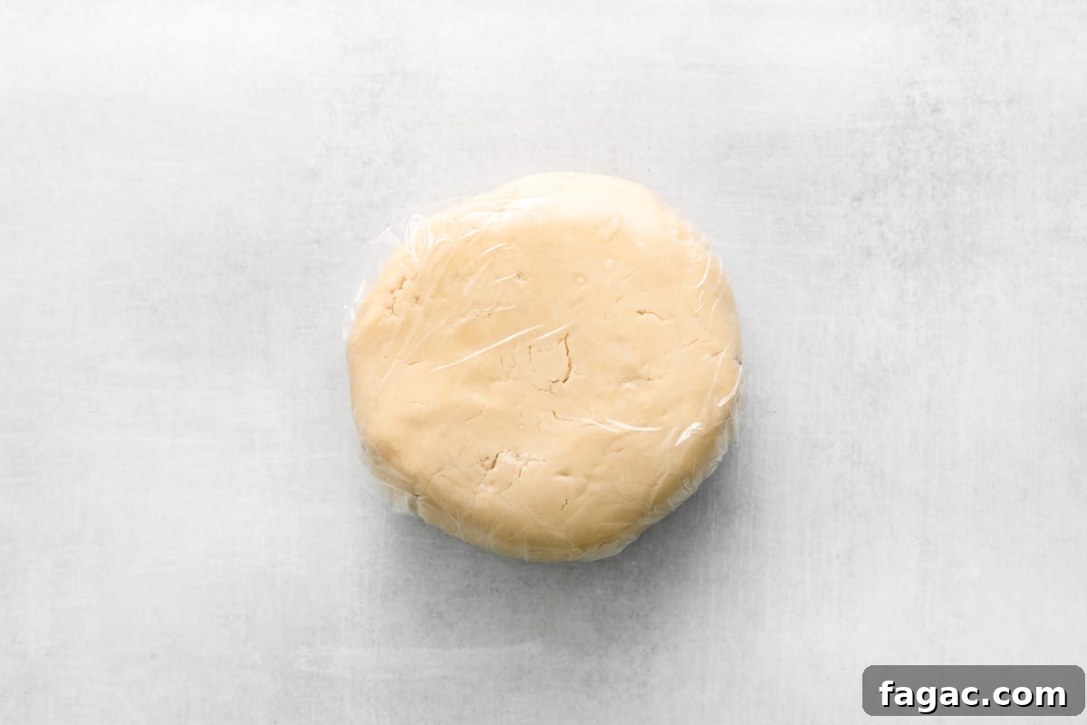 a round white dough wrapped in plastic.