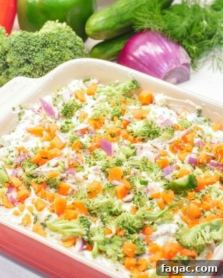 This easy veggie pizza dip is a no-bake party favorite loaded with cream cheese, ranch, herbs, cheddar cheese, and tons of chopped fresh veggies!