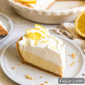 Creamy Lemon Icebox Pie Recipe 10 slice of lemon icebox pie with whipped cream and lemon slice garnish on a plate.