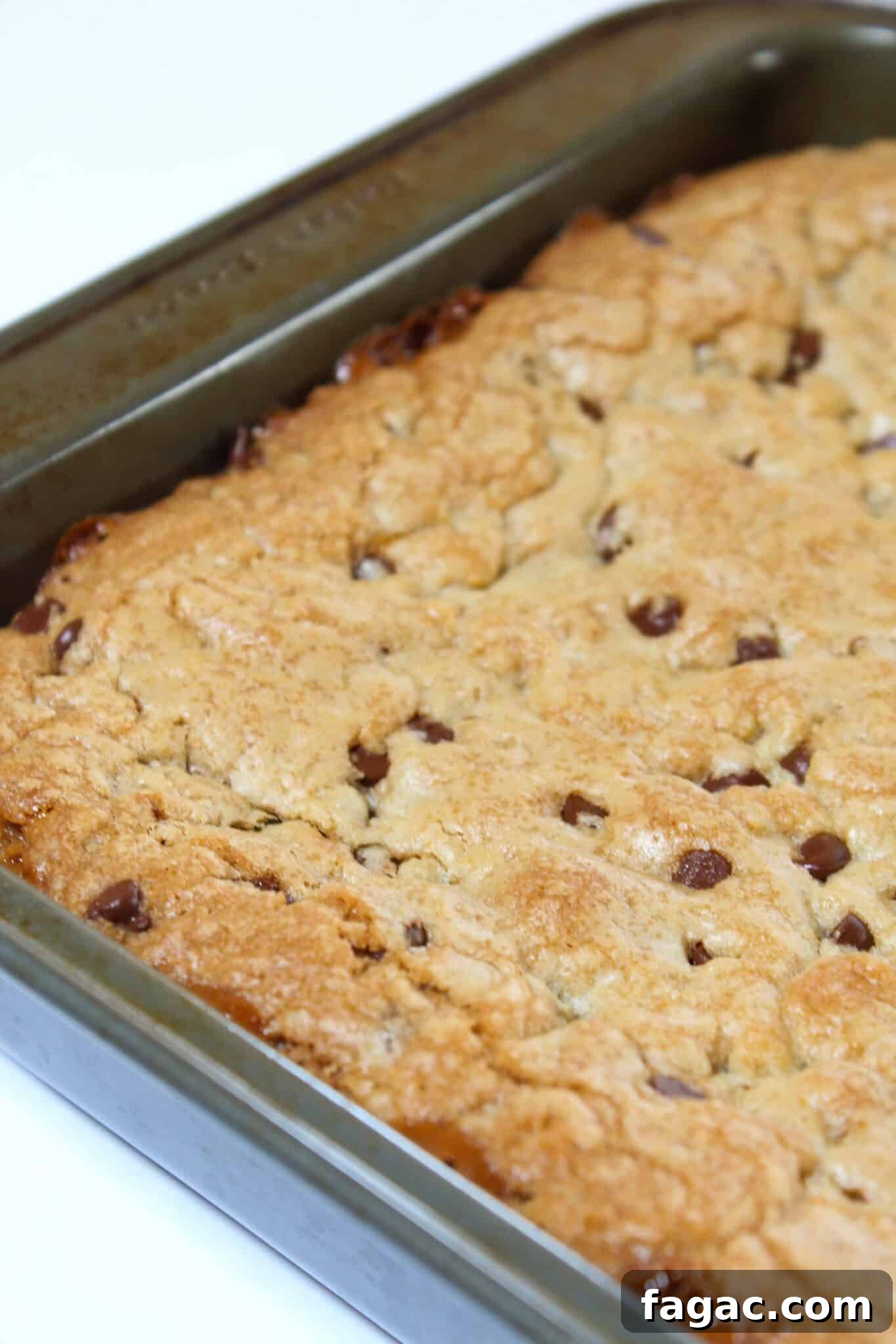 Salted Caramel Chocolate Chip Cookie Bars Recipe & Tips 12 Adding the remaining cookie dough and baking the cookie bars.