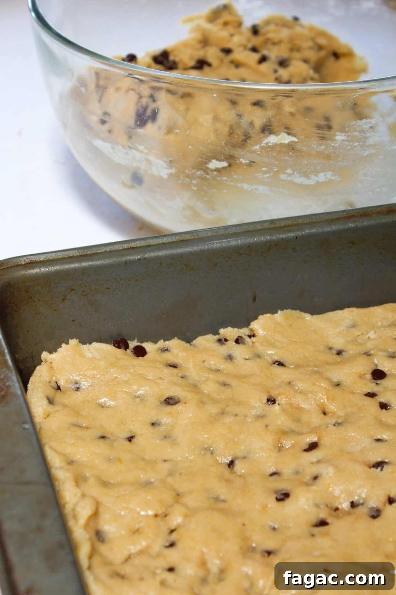Salted Caramel Chocolate Chip Cookie Bars Recipe & Tips 8 Adding chocolate chips and pressing the dough into a prepared pan.