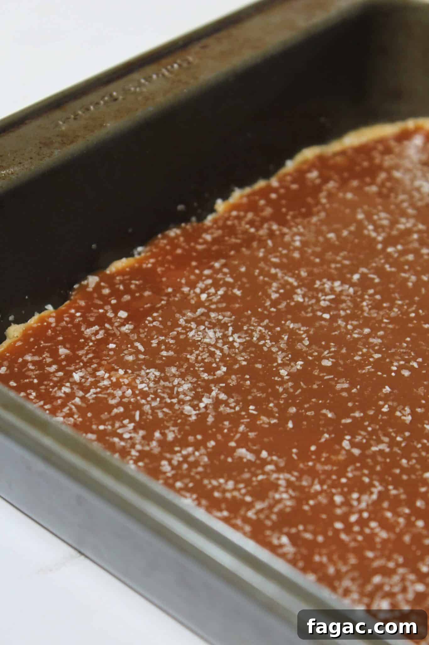 Salted Caramel Chocolate Chip Cookie Bars Recipe & Tips 10 Adding salted caramel to the top of half of the cookie dough.